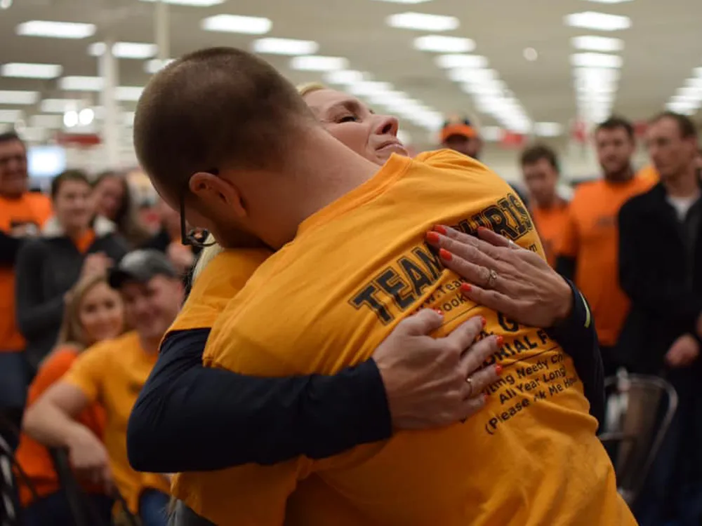 Suzanne Groom hugging a volunteer at a target shopping event